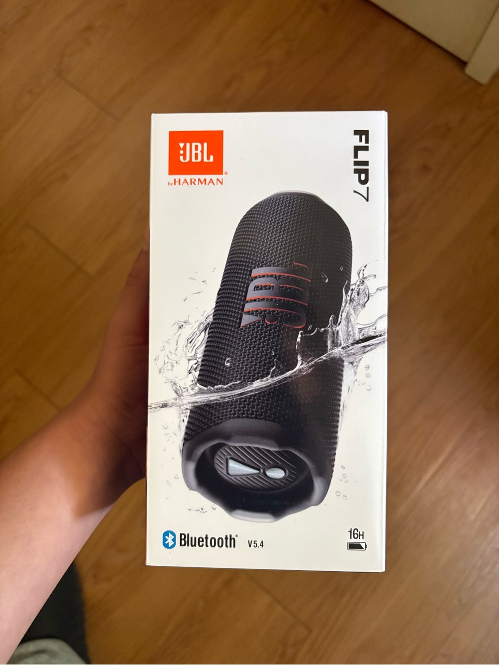 JBL Flip 7 Portable Bluetooth Speaker - Black with Orange Logo